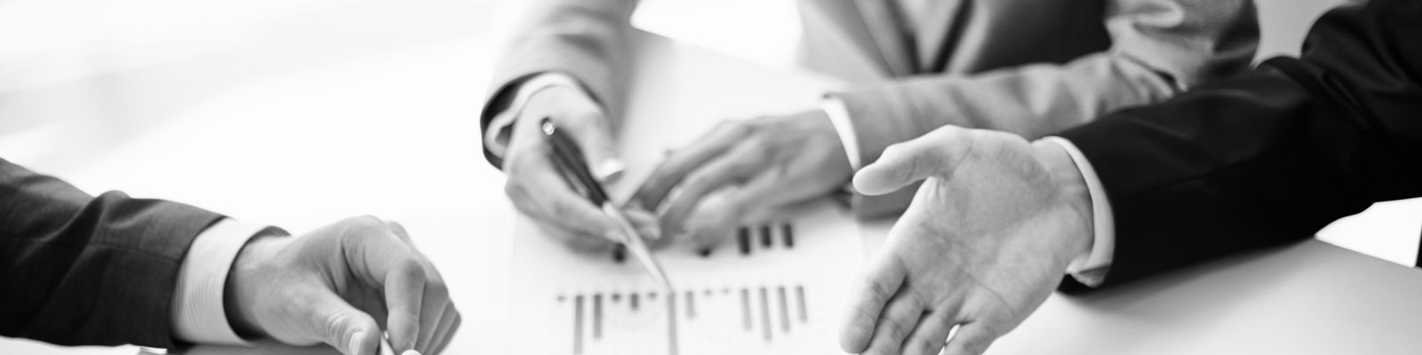 Image of business partners hands over business objects on workplace at meeting